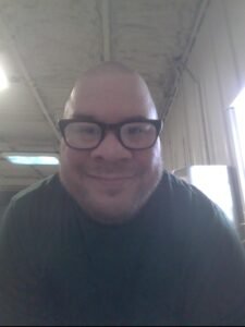 Clifford Morefield smiling and wearing glasses