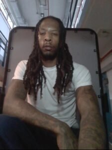 Joshua Carse seated in a white shirt